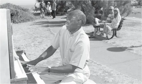  ??  ?? Dr. Carl Ivey, a.k.a Classical Carl, plays at Oak Bay Marina on one of the municipali­ty’s outdoor pianos. “Music is my passion,” he says. “And these pianos are connectors. They’re magnets. I have met people from all over the world.”