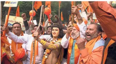  ?? — AP ?? Build it: A man dressed as Hindu god Ram (centre) rallying with activists to demand that a temple be built at Ayodhya in New Delhi.