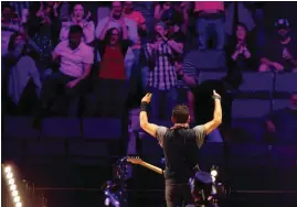  ??  ?? Bruce Springstee­n performs with the E Street Band during their concert at Chesapeake Energy Arena.