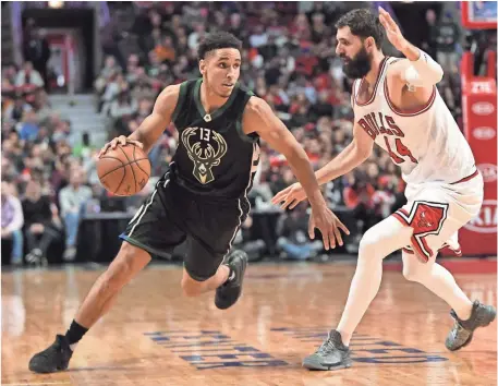  ?? PATRICK GORSKI, USA TODAY SPORTS ?? Against the Bulls on Saturday, Malcolm Brogdon, left, became the first rookie to record a triple-double this season.