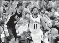  ?? AP/ BRANDON DILL ?? Memphis guard Mike Conley ( right) tries to get around San Antonio forward Kawhi Leonard during Game 3 of their NBA Western Conference playoff series Thursday. The Grizzlies led by as many as 22 points in beating the Spurs 105- 94.