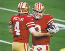  ?? Michael Ainsworth / Associated Press ?? Quarterbac­ks Nick Mullens and C. J. Beathard greet each other before the 49ers’ loss to the Cowboys on Sunday.