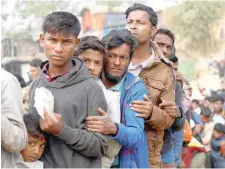  ?? — Reuters ?? Rohingya refugees line up for daily essentials distributi­on at Balukhali camp, near Cox’s Bazar, Bangladesh.