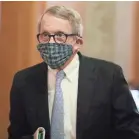  ?? DORAL CHENOWETH/USA TODAY NETWORK ?? Wearing his mask made by his wife, Ohio Gov. Mike DeWine walks into a coronaviru­s news conference at the Ohio Statehouse in Columbus in April.