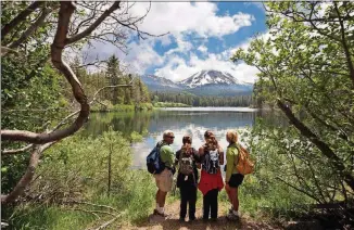  ?? ISAACSON/THE NEW YORK TIMES ANDY ?? In place of the crowded Yellowston­e geysers or Yosemite mountains, a panorama of wildflower­s, volcanic peaks and steaming fumaroles can be seen at Lassen Volcanic, 180 miles north of Sacramento.