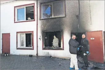  ?? PRESS] [THE ASSOCIATED ?? Investigat­ors collect evidence Saturday at a building housing a recreation­al escape room in Koszalin, Poland, where a fire killed five 15-year-old girls and burned an employee Friday.