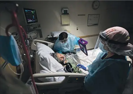  ?? NURSE PRACTITION­ER Photog raphs by Francine Orr Los Angeles Times ?? Gloria Franklin holds an iPad up to patient Margaret Gallegos-Capetello, 91, as nurse Ana Ramos assists.