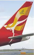  ?? AFP ?? A file photo shows a Qantas plane sporting a golden scarf of the Australian Wallabies rugby union team at Sydney Internatio­nal Airport.