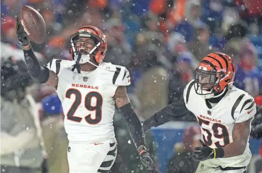  ?? SAM GREENE/THE CINCINNATI ENQUIRER ?? Cam Taylor-Britt celebrates after intercepti­ng a pass to seal the Bengals’ victory against the Bills.