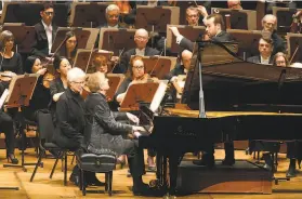  ?? Kristen Loken ?? JeanYves Thibaudet solos on the piano with conductor Fabien Gabel and the San Francisco Symphony in Aaron Zigman’s piano concerto “Tango Manos.”