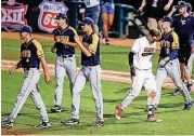  ?? [PHOTO BY NATE BILLINGS, THE OKLAHOMAN] ?? Oklahoma State’s Michael Neustifter (15) leaves the field after being the last out for the Cowboys in the bottom of the ninth inning in their 8-5 loss to West Virginia on Wednesday.