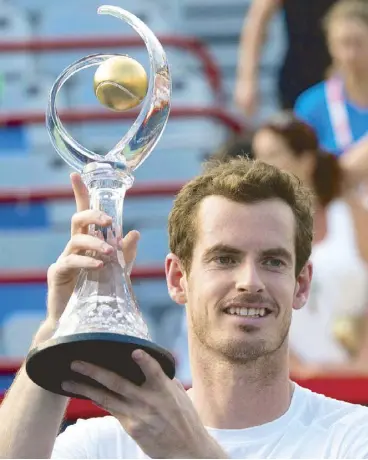  ??  ?? Andy Murray raises the Rogers Cup following his victory over Novak Djokovic of Serbia at the Rogers Cup tennis tournament in Montreal.