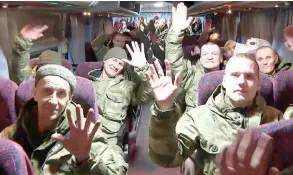  ?? ?? Russian prisoners of war (POWs) inside a bus a er arriving on a plane at an airfield in the capital Moscow, a day a er a prisoners swap with Ukraine.