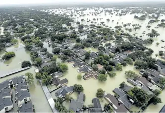  ?? DAVID J. PHILLIP/ AP PHOTO ?? Water from Addicks Reservoir flows into neighborho­ods as floodwater­s from Tropical Storm Harvey rise in Houston.