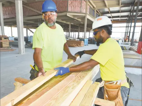  ?? Hearst Connecticu­t Media file photo ?? Carpentry intern Jason Kenworthy works alongside journeyman carpenter Manoah Dundar while learning the constructi­on trade at the SoNo Collection mall in Norwalk through a General Growth Properties internship last summer.