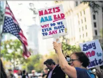  ?? CP PHOTO ?? People protest against the white supremacis­t movement and racism outside the United States consulate in Toronto on Monday.