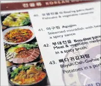  ?? AP PHOTO ?? The menu at a Korean restaurant includes photos showing a neat arrangemen­t of SPAM and other meats in Shoreline, Wash