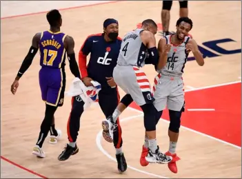  ?? AP Photo/Nick Was ?? Washington Wizards guard Ish Smith (14) celebrates after his dunk with guard Russell Westbrook (4) and guard Bradley Beal (second from left) during the second half of an NBA basketball game as Los Angeles Lakers guard Dennis Schroder (17) walks by, on April 28 in Washington.