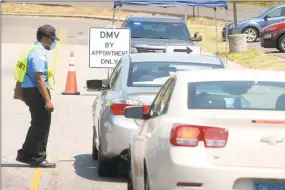  ?? Ned Gerard / Hearst Connecticu­t Media ?? A security guard checks motorists in as they arrive for appointmen­ts at the state Department of Motor Vehicles office in Bridgeport on Tuesday.