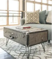  ?? DIY NETWORK ?? New coffee table not in the budget? Upcycle an old suitcase by adding table legs.