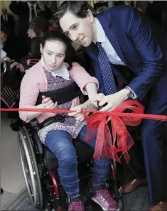  ??  ?? Head Girl Rianna Dempsey helps Minister Simon Harris to cut the ribbon on the new playground.