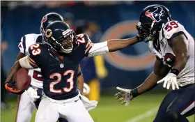  ?? CHARLES REX ARBOGAST — THE ASSOCIATED PRESS ?? The Bears’ Devin Hester (23) stiff-arms the Texans’ Whitney Mercilus (59) during a punt return in a 2012 game in Chicago.