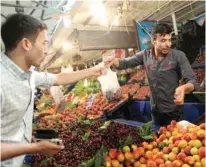  ?? – File Photo ?? DOWNWARD TREND: A man buys cherries in a market in Ankara, Turkey.