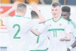  ??  ?? Spot on: Northern Ireland’s Chris Hutchinson celebrates after scoring a penalty against Wales yesterday