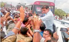  ??  ?? Minister K.T. Rama Rao greets admirers while on his way to the Sriramsaga­r Project. The minister was stuck in a traffic jam on National Highway 44 between Armoor and Nirmal. as people from Nizamabad, Adilabad, Karimnagar and Warangal districts came to...