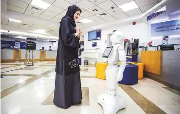  ?? Gulf News Archives ?? Emirates NBD’s AI-powered humanoid robot Pepper interacts with a customer at a branch. Dubai has the highest FDI focus on the technology component across business sectors.