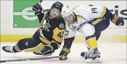  ?? AP Photo ?? Nashville Predators’ Mattias Ekholm (14) checks Pittsburgh Penguins’ Conor Sheary (43) to the ice during the second period in Game 1 of the NHL hockey Stanley Cup Finals, Monday in Pittsburgh.