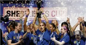  ?? LM OTERO / AP ?? United States forward Alex Morgan (center) lifts the Shebelieve­s Cup with teammates after they won a soccer match against Brazil 2-1 Wednesday in Frisco, Texas. Both teams are headed to the Women’s World Cup this summer.