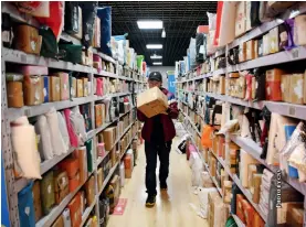  ??  ?? Shelves are full of parcels at a university after the Double Eleven Shopping Festival, an e-commerce sales promotion which takes place every November