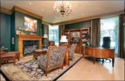  ?? ?? Hallmarks of the study include stained-wood crown molding and a gas-log fireplace with an Italian marble surround.
