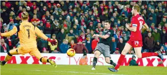  ?? AP ?? Southampto­n’s Shane Long (centre) scores in their League Cup semifinal second leg match against Liverpool at Anfield Stadium on Wednesday. The visitors won 1-0 and advanced to the final on a 2-0 aggregate. —