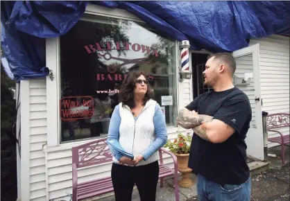  ?? Tyler Sizemore / Hearst Connecticu­t Media ?? Business owners Kyle and Suzann Benevelli survey the fire damage to Belltown Barbers in Stamford on Wednesday. A fire on Sept. 25 caused significan­t damage to Belltown Barbers and the adjoining business, Sandra’s Mexican Food & Taqueria.