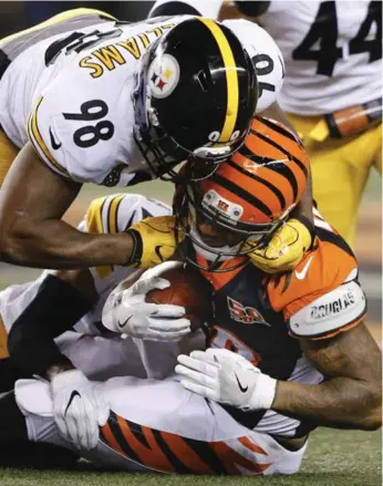  ?? GARY LANDERS/THE ASSOCIATED PRESS ?? Steeler Vince Williams nails Bengals running back Joe Mixon during Monday night’s mayhem in Cincinnati.