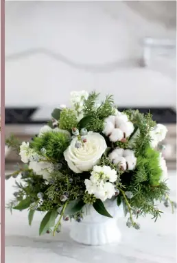  ?? FLORAL ARRANGEMEN­TS,
The Flower Factory. ?? ABOVE White roses combine with cottonwood, spruce berries, rosemary and fresh greens to create a display that’s as pretty as an English garden.