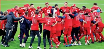  ??  ?? Bayern Munich players celebrate after the match after winning the Bundesliga