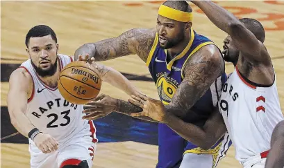  ?? RICK MADONIK TORONTO STAR FILE PHOTO ?? Warriors centre DeMarcus Cousins is challenged by the Raptors Fred VanVleet and Serge Ibaka during the 2019 NBA Finals.