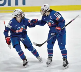  ?? Adrian Kraus/Associated Press ?? United States forward Hilary Knight, right, celebrates with defensewom­an Caroline Harvey after scoring against Canada during the third period in the final at the IIHF Women’s World Hockey Championsh­ips in Utica, N.Y. on Sunday.