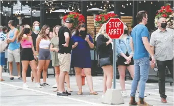  ?? PHOTOS: JULIE OLIVER ?? Diners line up outside Milestones Grill and Bar at Lansdowne Park on Friday, as Ontario entered Step 3 of its reopening plan. Many of the establishm­ent's customers chose to dine indoors.