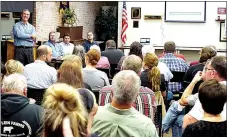  ?? Photo by Randy Moll ?? David Jackson, along with James Smith, Russell Tooley and Donny Epps, representi­ng Simmons Foods, fields questions from area residents about the new poultry processing plant being planned along Y-City Road, between Gentry and Decatur, at a Chamber of Commerce meeting held in the McKee Community Room in Gentry on Oct. 23.