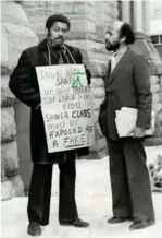  ?? ERIN COMBS ?? Dildy at an anti-Santa protest outside the Eaton Centre in 1980 with lawyer Charles Roach. Dildy was charged with causing a disturbanc­e.