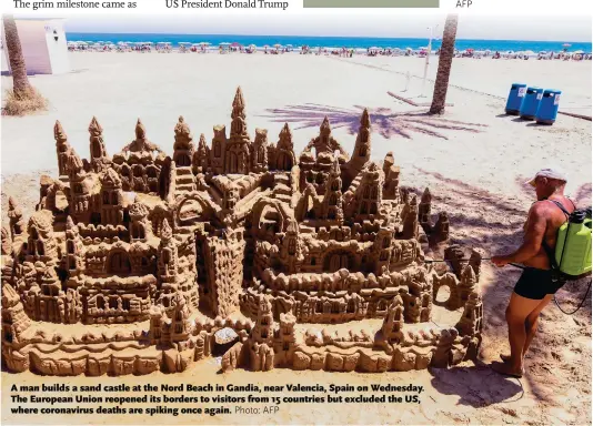  ?? Photo: AFP ?? A man builds a sand castle at the Nord Beach in Gandia, near Valencia, Spain on Wednesday. The European Union reopened its borders to visitors from 15 countries but excluded the US, where coronaviru­s deaths are spiking once again.