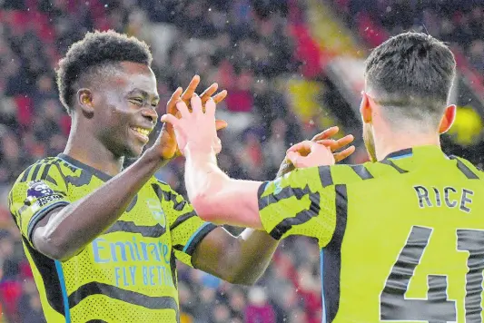  ?? AP ?? Arsenal’s Bukayo Saka (left) and Declan Rice celebrate after Sheffield United’s Jayden Bogle scored an own goal past his goalkeeper during the English Premier League match between Sheffield United and Arsenal at the Bramall Lane stadium in Sheffield, England yesterday.