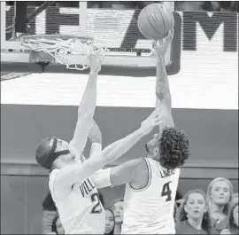  ?? Matt Slocum Associated Press ?? MICHIGAN’S ISAIAH LIVERS, right, lays up a shot against Villanova’s Joe Cremo on Wednesday. The Wolverines led wire to wire and upset the Wildcats.