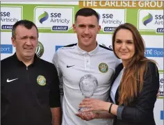  ??  ?? Bray Wanderers’ May Player of the Month Aaron Greene receiving his award at last Friday’s game against Derry City from Alicja Winkler from Aaron’s sponsor Tax Assist Bray alongside Rob Pierce from the Seagulls Members Club.