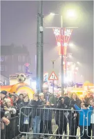  ??  ?? Festive fun Crowds enjoy the entertainm­ent at Cambuslang’s switch-on celebratio­ns on Sunday