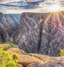  ??  ?? The Painted Wall rises more than 2,000 feet from the river in a nearly vertical cliff.